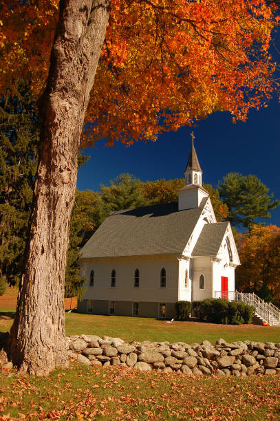Sharon, CT, USA October 20, 2007 A small, classic New England chapel is nestled under a colorful autumn tree on Sharon, Connecticut