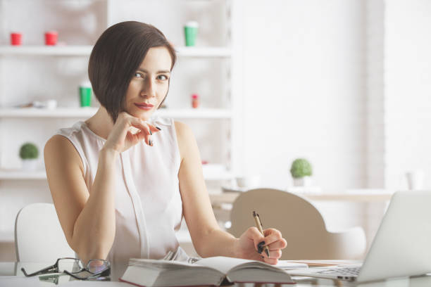 istock Beautiful businesswoman working on project 697403624
