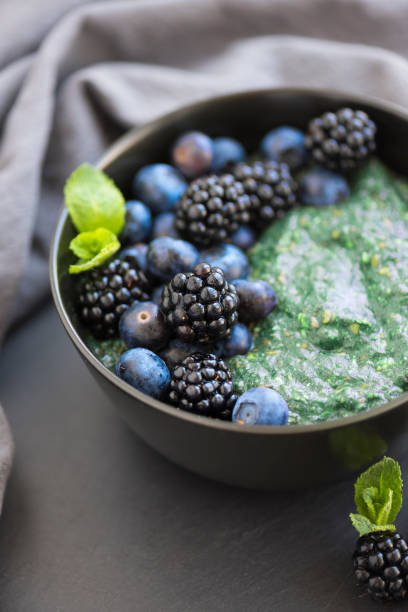Healthy organic spirulina porridge topped with berries