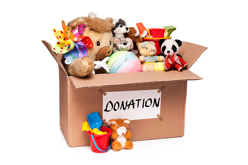 Donation box with toys isolated on white background