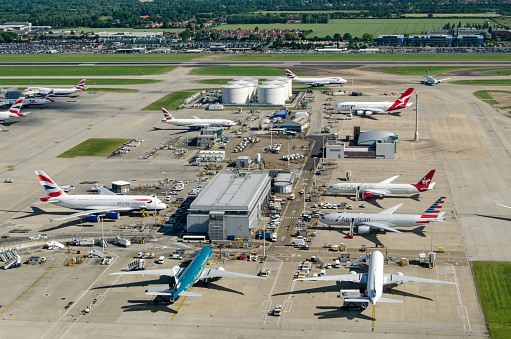 LONDON, UK - JUNE 3, 2017:  Commercial airliners parked near the northern fuel supplies at London's busy Heathrow Airport on a sunny summer morning.  Planes using the facility include British Airways, Americal Airlines, Cathay Pacific and Qantas.