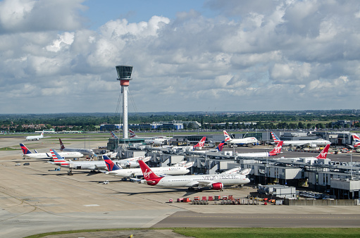 LONDON, UK - JUNE 3, 2017:  View from the air of planes parked at Terminal 3 of London's Heathrow Airport on a sunny summer morning.  Virgin Atlantic, Delta and American Airlines all use this part of the busy airport.