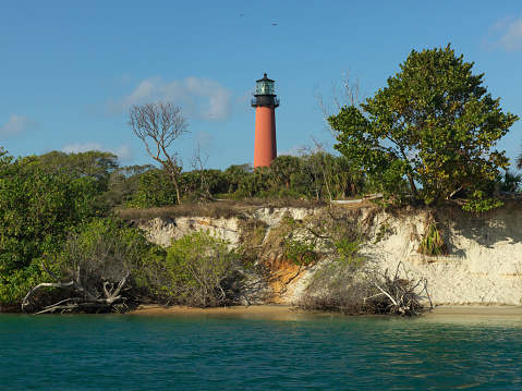 Jupiter Inlet Lighthouse behind the bluffs of the Intracoastal Waterway of Florida.