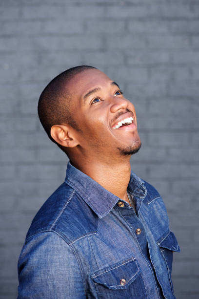 istock happy young black guy laughing and looking up 697427284