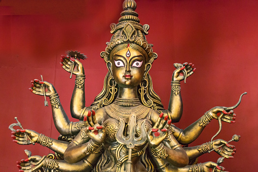 Artistic Hindu goddess Durga idol in terracotta. Durga is seen to fight with the demon Mahishasura signifying a win of good over evil.
