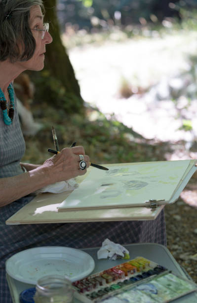 istock Senior woman painting, vertical 697435314