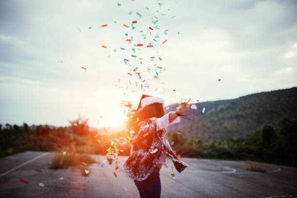 istock Woman dancing and throwing cofetty 697439582
