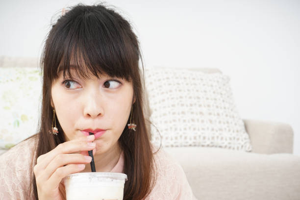 Young woman drinking coffee at room