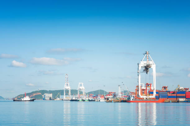 istock Container Cargo freight ship with working crane bridge in shipyard at dusk for Logistic Import Export background 697445892