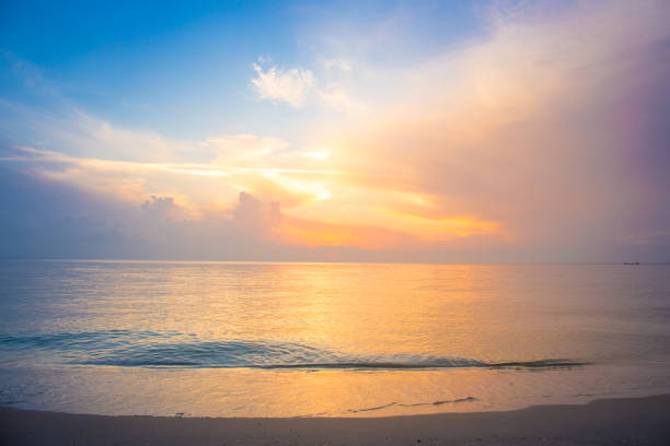 istock Beautiful sky, sunrise and waves at the beach 697449164