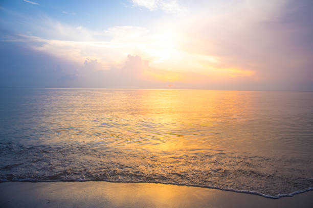 istock Beautiful sky, sunrise and waves at the beach 697449166