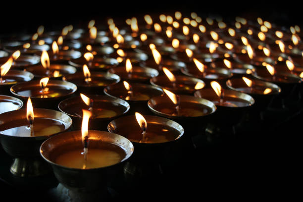 istock Charity. Praying candles in a temple. 697449344