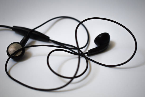 istock Black earphones on white background 697451640