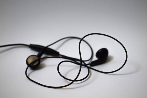 istock Black earphones on white background 697452282