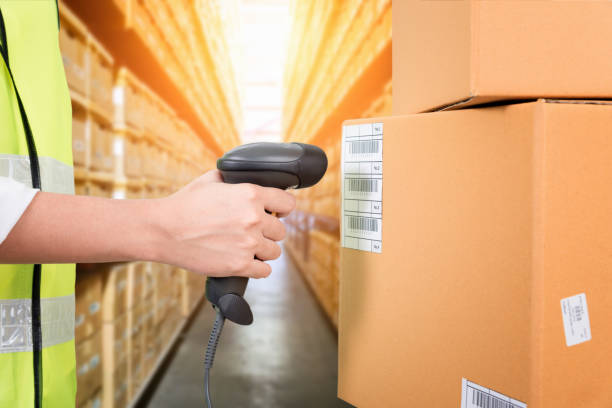 istock Woman scanning barcode from a label in modern warehouse 697462150
