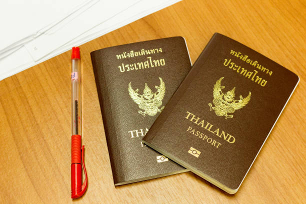 istock Close up Thailand passport and on wood 697465116