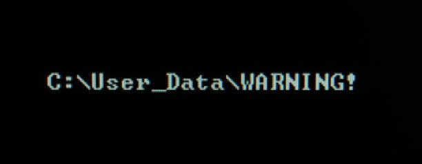 istock Computer screen shot of black background and white warning security text 697475776