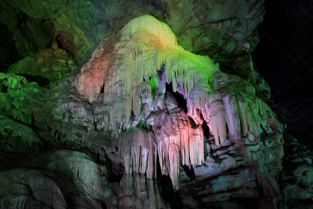 istock Colorful cave stalactites formation. 697475798