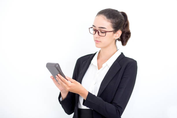 istock Serious female accountant counting on calculator 697476270