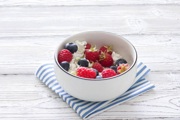 istock Homemade cottage cheese with fresh berries 697476522