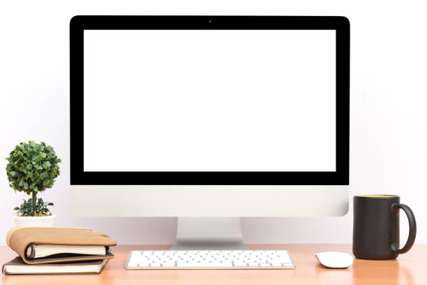 istock Office monitor computer, mouse on wooden table and white wall background 697476594