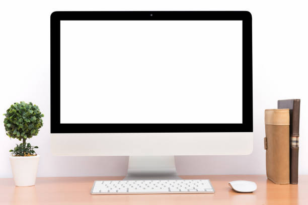 istock Office monitor computer, mouse on wooden table and white wall background 697476610