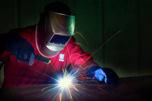 istock Industrial Worker at the factory welding closeup 697478904