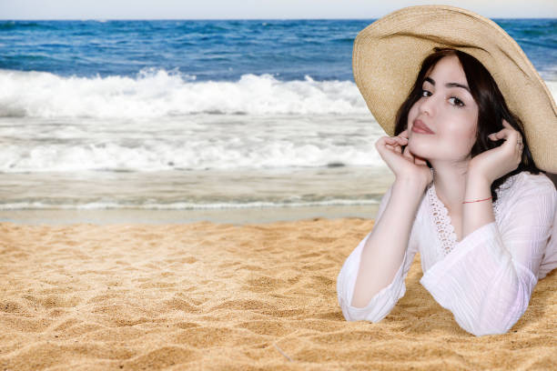 istock young girl on beach in straw hat 697481794