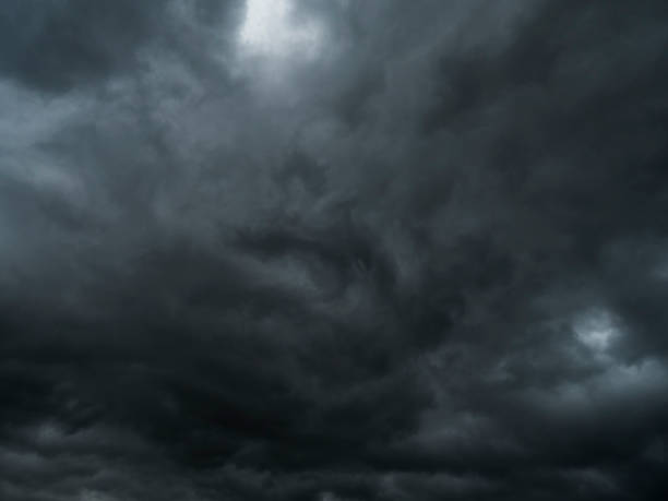 istock storm and rain clouds in dark sky nature background 697489160