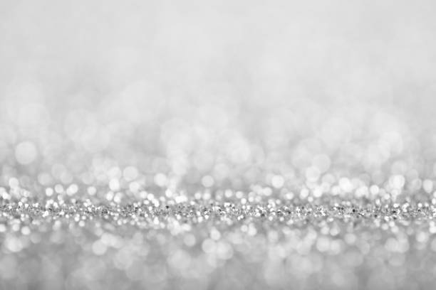 Abstract Silver Defocused Lights Background Abstract background of silver glittering defocused lights. greyscale stock pictures, royalty-free photos & images