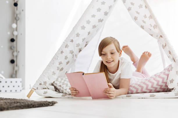 istock Charming enthusiastic child enjoying her hobby at home 697490112