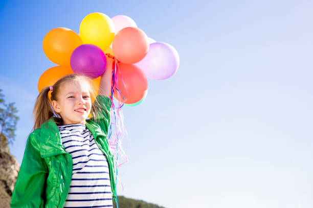istock Girl is having fun with balloons 697492522