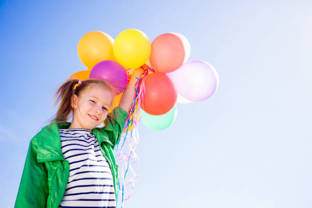 istock Girl is having fun with balloons 697492542
