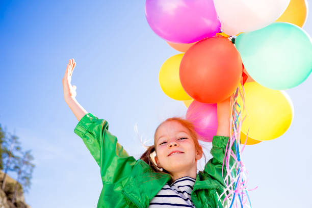 istock Girl is having fun with balloons 697492568