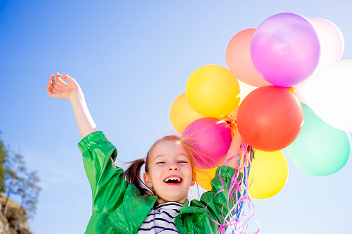 Girl is having fun with colorful balloons