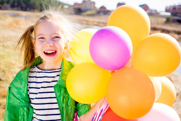 istock Girl is having fun with balloons 697492638