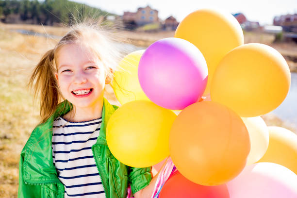 istock Girl is having fun with balloons 697492650