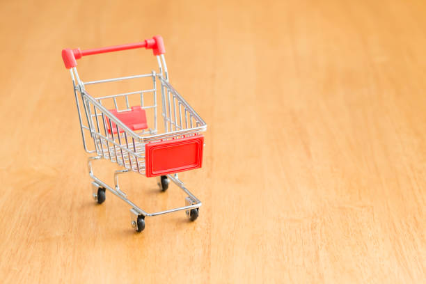 istock shopping cart on wood table 697493146
