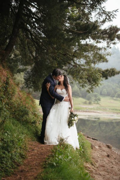 istock Affectionate bride and groom embracing and kissing 697493634