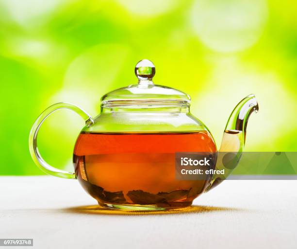 Teapot Of Fresh Tea On Natural Background Stock Photo - Download Image Now - Black Tea, Teapot, Glass - Material