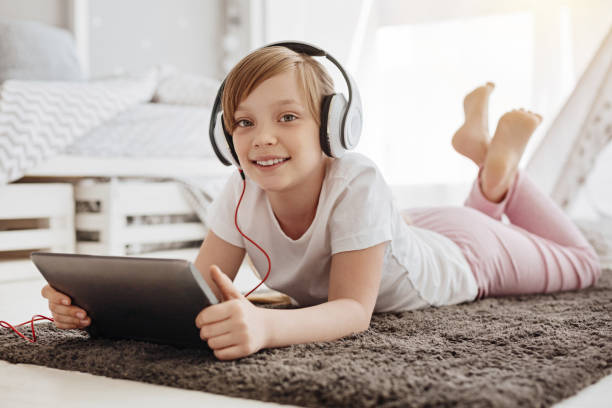 istock Imaginative joyful child watching cartoons 697493860