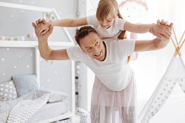 istock Charismatic funny father playing with his daughter 697496312