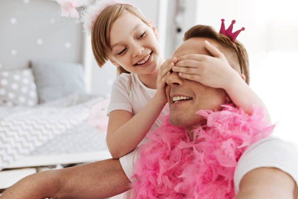 istock Cute fun child surprising dad with his new look 697496700