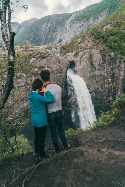 istock Couple looking at Manafossen waterfall in Norway 697503148