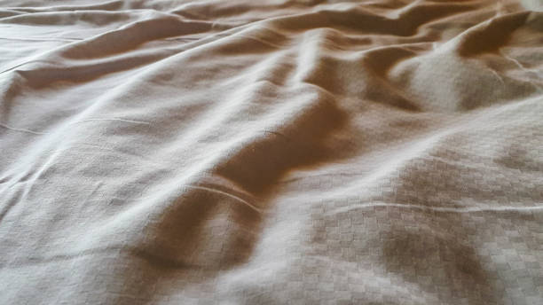 istock Messy white sheeting of bed 697514350