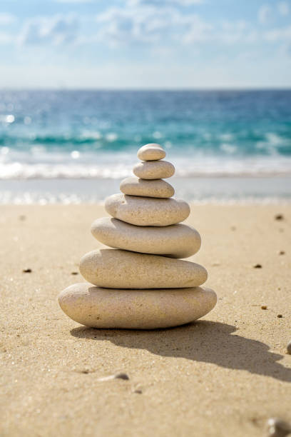 istock Stacked tower of balancing smooth pebbles. 697517944