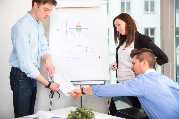 istock Business People Discussing Over Document In Office 697520380