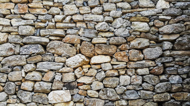 istock Natural stone wall of ancient houses 697521990