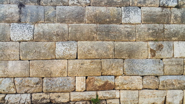 istock Block stone wall of ancient church 697523264