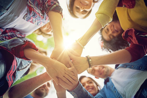 istock Happy friends are looking their united hands 697524606